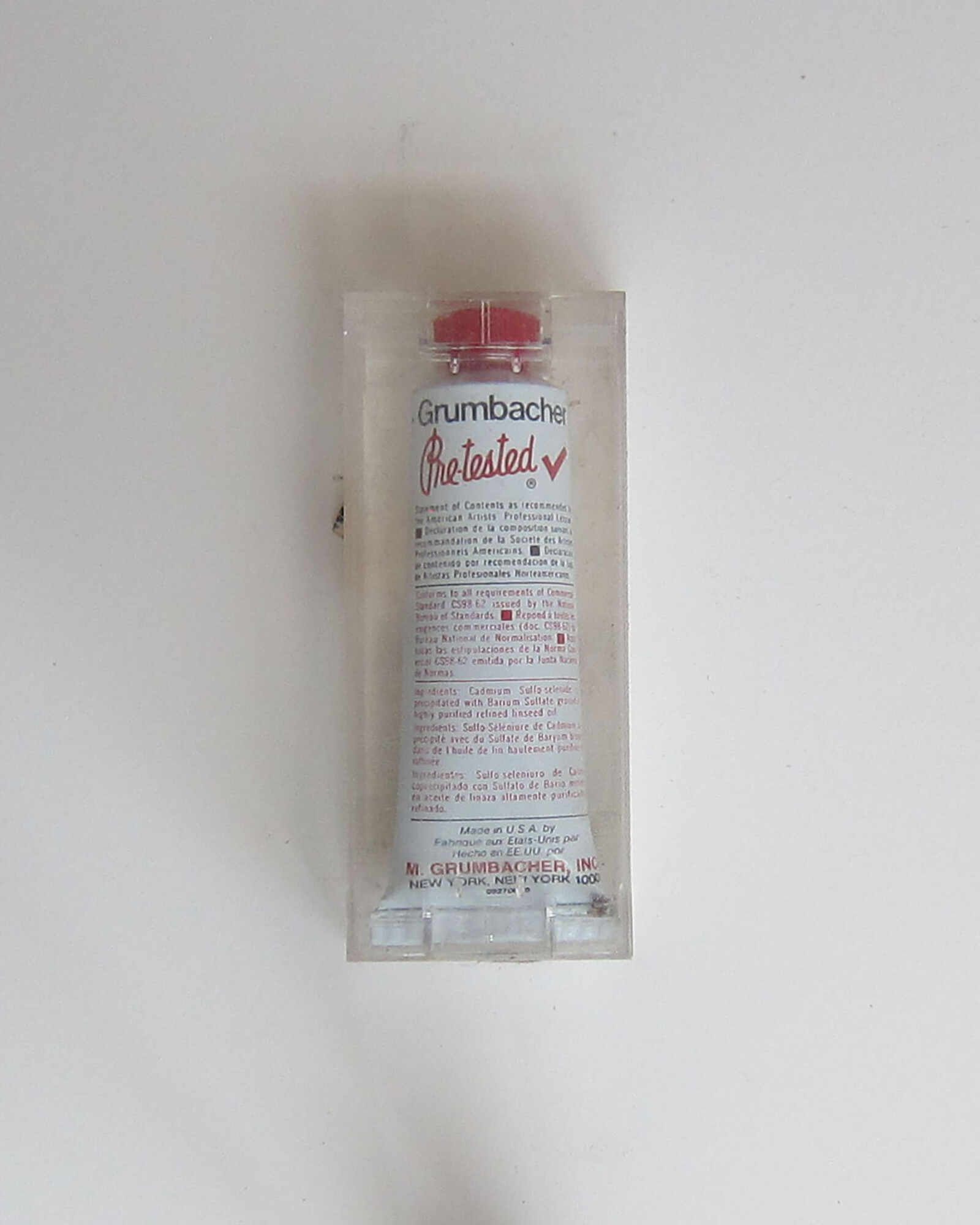 Studio Materials, Unopened clear plastic box with tube of Grumbacher Oil Color in the shade "Cadmium Red, Medium" inside.